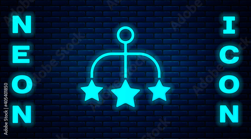Glowing neon Baby crib hanging toys icon isolated on brick wall background. Baby bed carousel. Vector.
