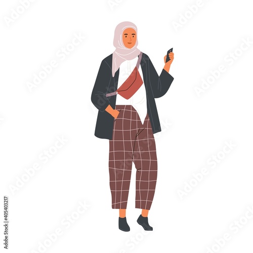 Modern Muslim woman wearing trendy casual clothes and hijab using phone. Fashion Arab female character in trousers and traditional headdress. Flat vector illustration isolated on white background