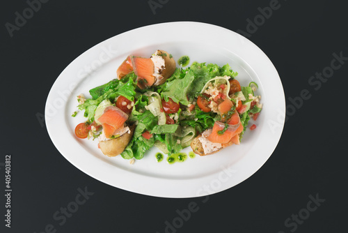 a plate of delicious salad on a black background