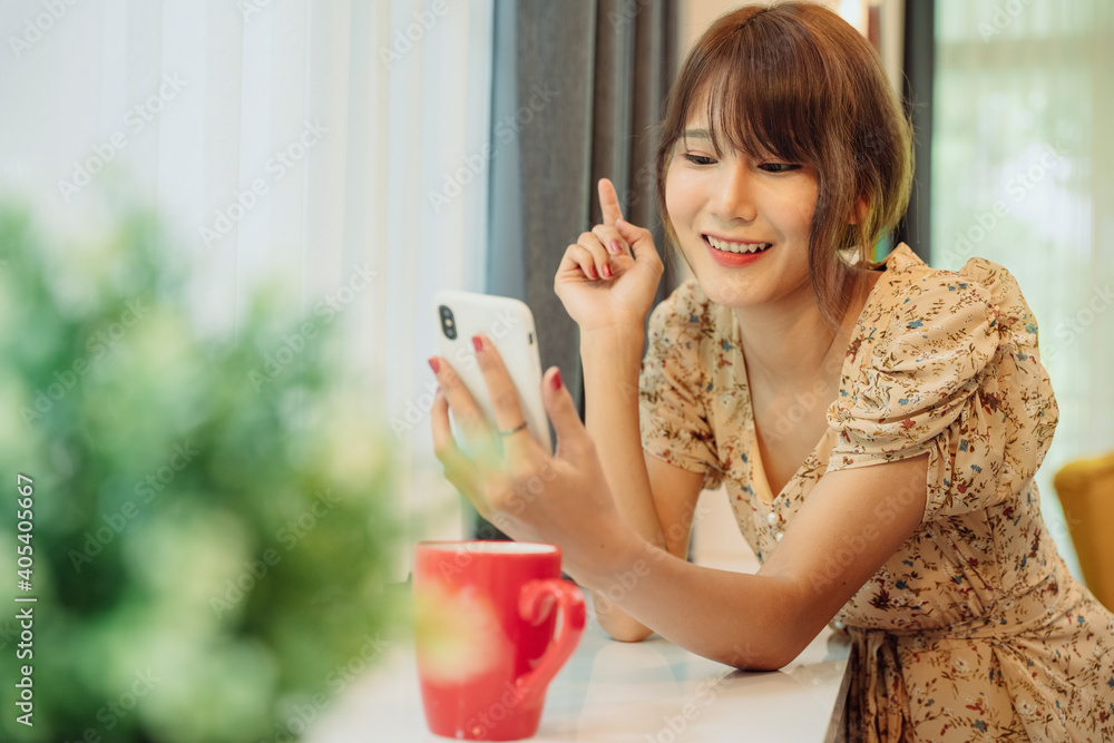 Beautiful asian thai woman using smartphone for online service in the house. Beautiful asian thai woman using smartphone for online service in the house.
