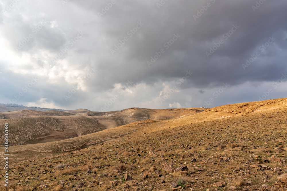 View of the rocky hills of the Judean Desert under a stormy sky. Landscape