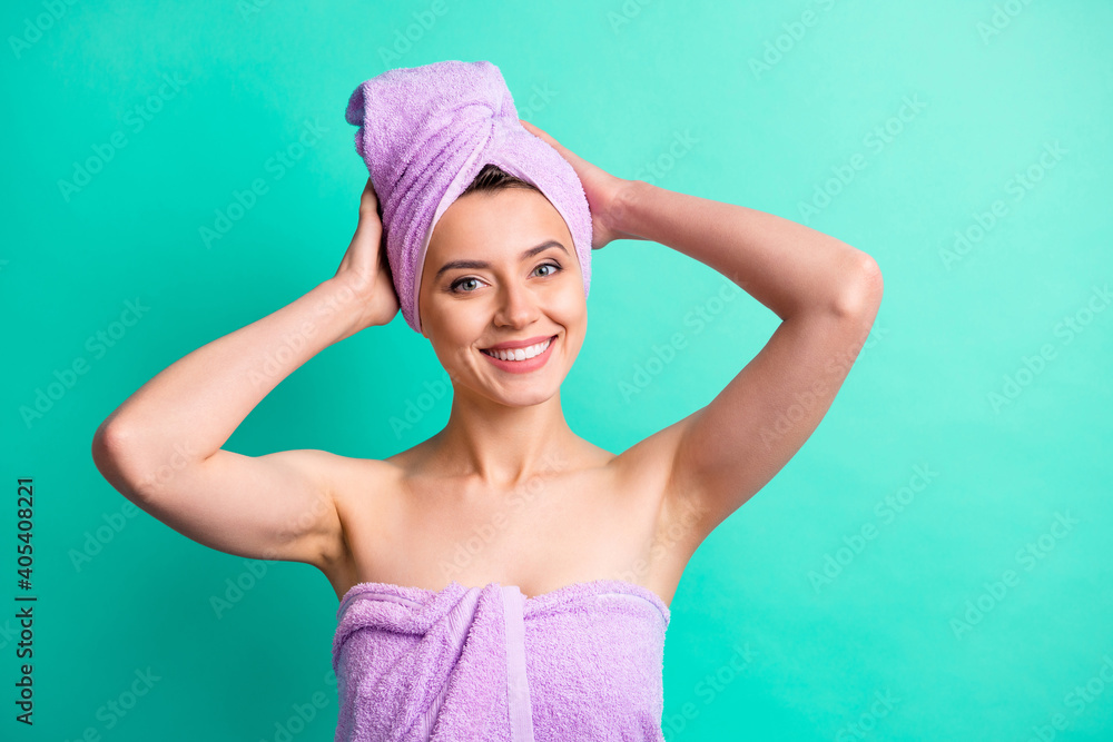 Photo portrait of girl in pink towel making turban on head after spa smiling isolated on vivid turquoise color background Photo portrait of girl in pink towel making turban on head after spa smiling isolated on vivid turquoise color background