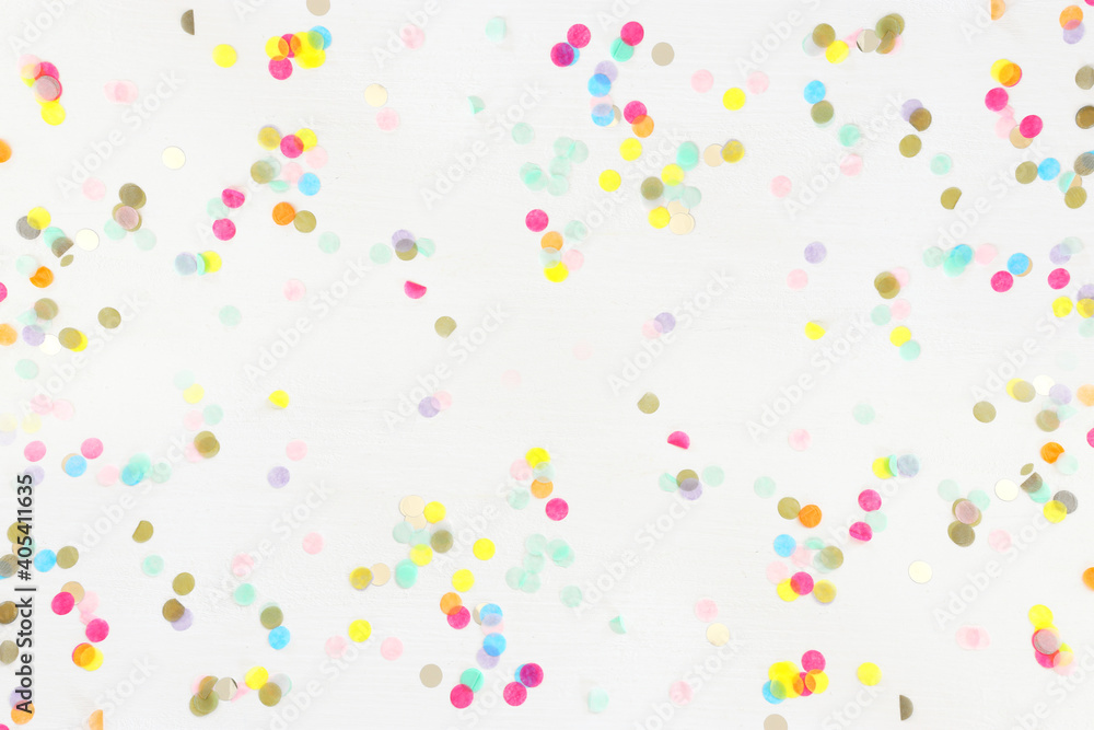 Party colorful confetti over white wooden background . Top view, flat lay - obrazy, fototapety, plakaty 