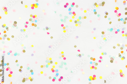 Party colorful confetti over white wooden background . Top view, flat lay photo