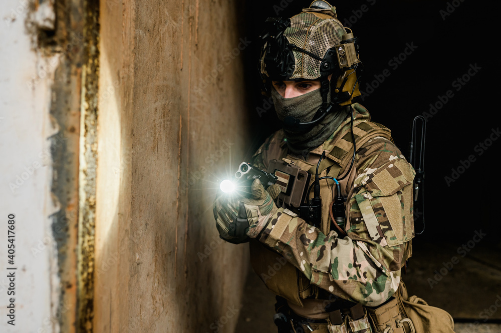 Special forces soldier doing tactical training in building clearing (CQB). He is wearing multicam uniform and XDM 9mm gun. Special forces soldier doing tactical training in building clearing (CQB). He is wearing multicam uniform and XDM 9mm gun.