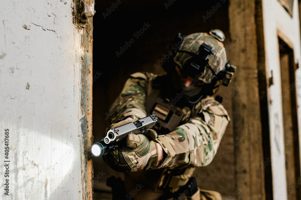 Special forces soldier doing tactical training in building clearing (CQB). He is wearing multicam uniform and XDM 9mm gun. Special forces soldier doing tactical training in building clearing (CQB). He is wearing multicam uniform and XDM 9mm gun.