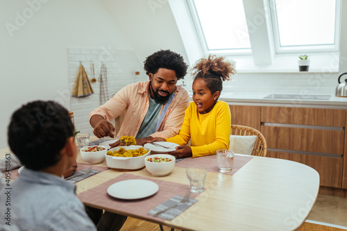 Afro family eating together at home