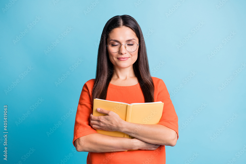 Photo of charming lady arms embrace book closed eyes eyewear isolated on pastel blue color background Photo of charming lady arms embrace book closed eyes eyewear isolated on pastel blue color background