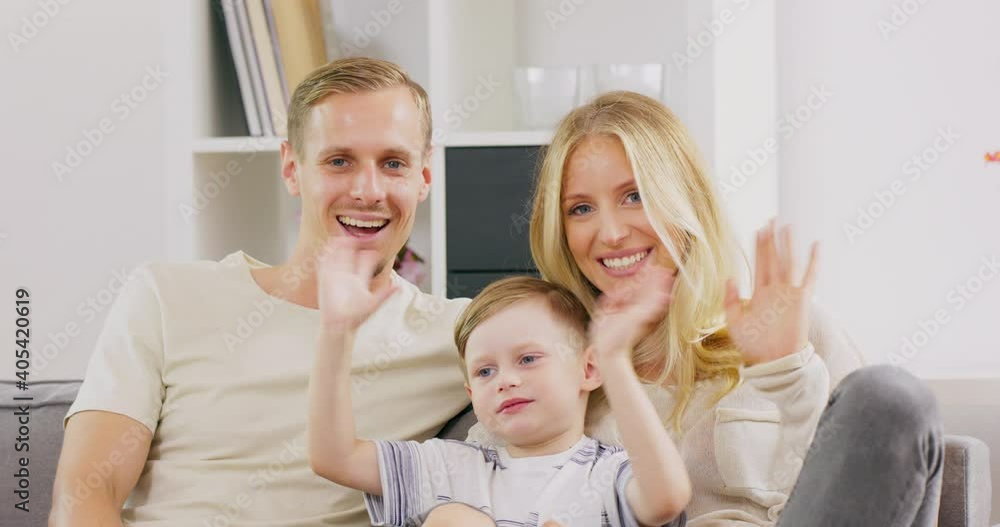 Happy parents sit on couch at home with cute little son wave talk on webcam, smiling young family with preschooler boy kid have conversation or shoot record vlog for social media together. Happy parents sit on couch at home with cute little son wave talk on webcam, smiling young family with preschooler boy kid have conversation or shoot record vlog for social media together.