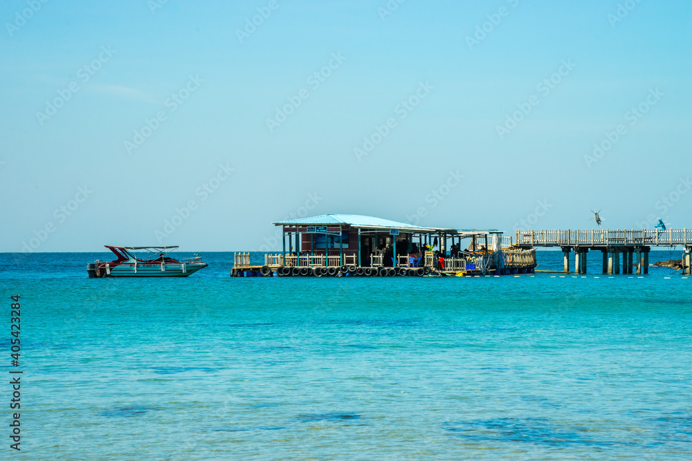 Beautiful landscape of Hon Thom beach, Phu Quoc island, Vietnam, Asia with tourist, chairs and umbrella. White sand and coco palms travel tourism and swing under tree.