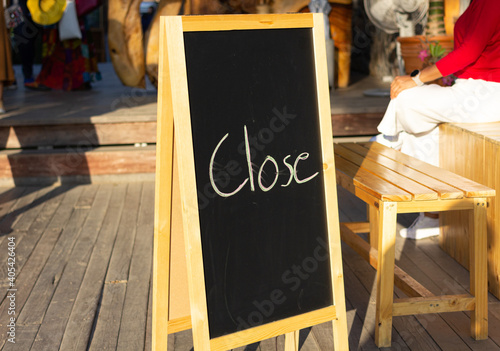 Menu black board with wooden frame on the floor in the restaurant. Text information 