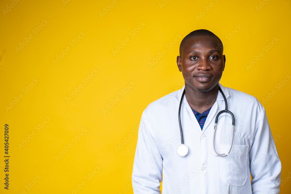 young handsome black medical doctor wearing his lab coat and hanging his stethoscope on his neck young handsome black medical doctor wearing his lab coat and hanging his stethoscope on his neck