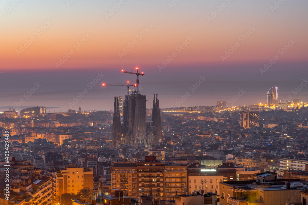Barcelona, Spain - Feb 24, 2020: Sagrada Familia with lights before sunrise in winter