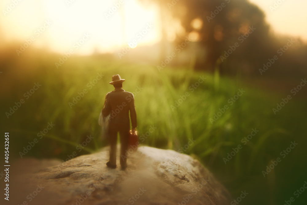 Surreal image of mysterious man walking alone during sunset Surreal image of mysterious man walking alone during sunset
