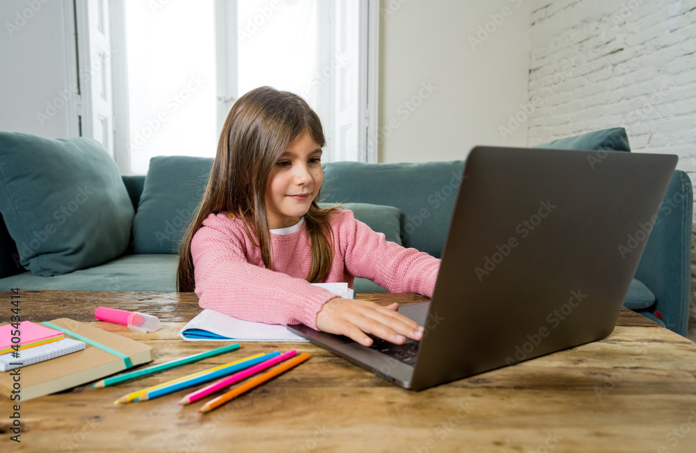 School girl with laptop studying online at home as school is closed due to new COVID-19 Lockdown School girl with laptop studying online at home as school is closed due to new COVID-19 Lockdown