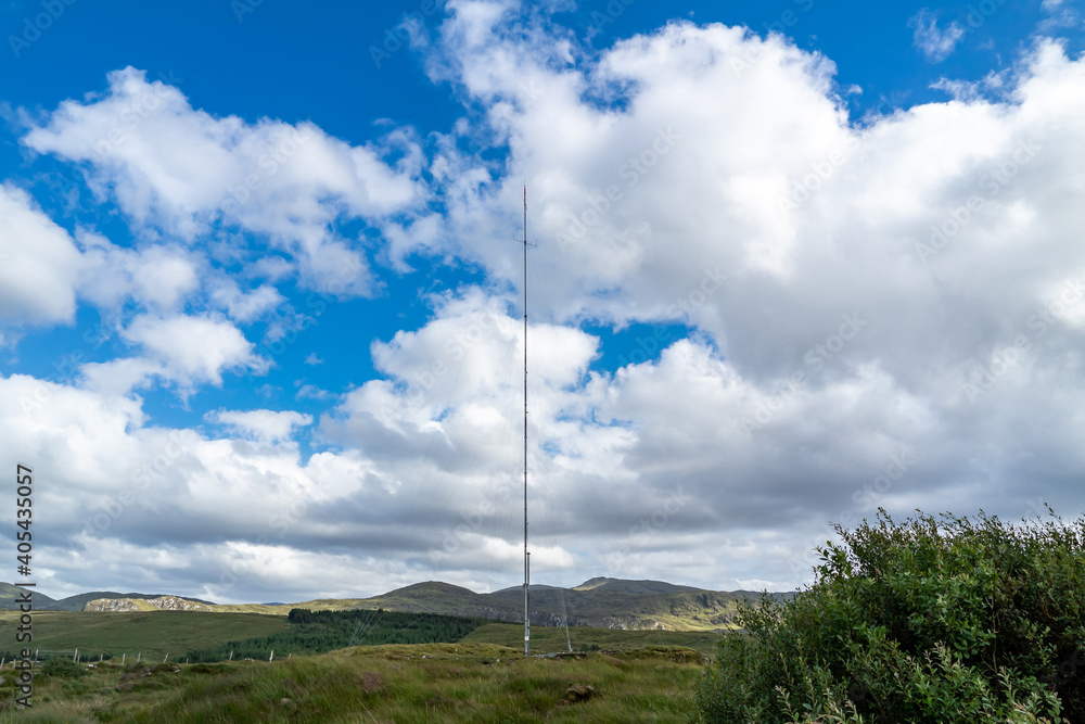 Street view of transmitter tower on an agricultural field in the irish highlands by Glenties in County Donegal. Street view of transmitter tower on an agricultural field in the irish highlands by Glenties in County Donegal.