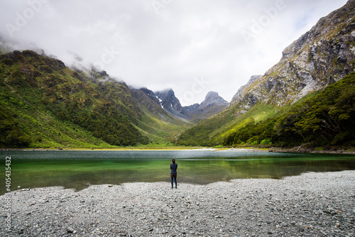 Wallpaper Mural Person stand in front of Emily Peak in Lake Mackenzie at the famous Routeburn Track, Fjordland National Park, Southland, New Zealand Torontodigital.ca