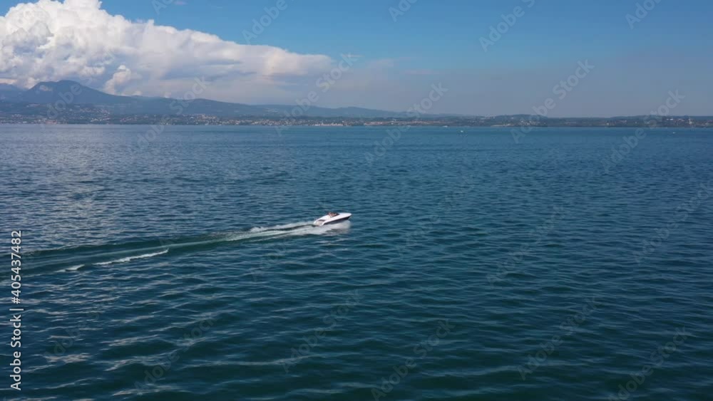 Boat on the water. Drone view of a boat the blue clear waters. Large white boat fast movement on blue water, sun reflection in the water, view from the top to the boat 4k video. Boat on the water. Drone view of a boat the blue clear waters. Large white boat fast movement on blue water, sun reflection in the water, view from the top to the boat 4k video.