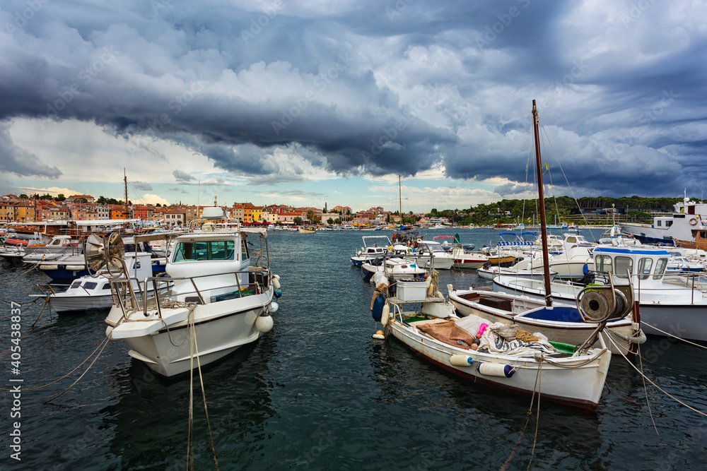fishing boats moored at the pier in harbour of Rovinj town, Croatia.