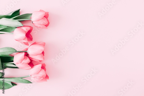 Beautiful composition spring flowers. Bouquet of pink tulips flowers on pastel pink background. Valentine's Day, Easter, Birthday, Happy Women's Day, Mother's Day. Flat lay, top view, copy space #405440069