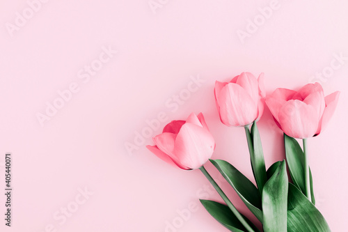 Beautiful composition spring flowers. Bouquet of pink tulips flowers on pastel pink background. Valentine's Day, Easter, Birthday, Happy Women's Day, Mother's Day. Flat lay, top view, copy space photo