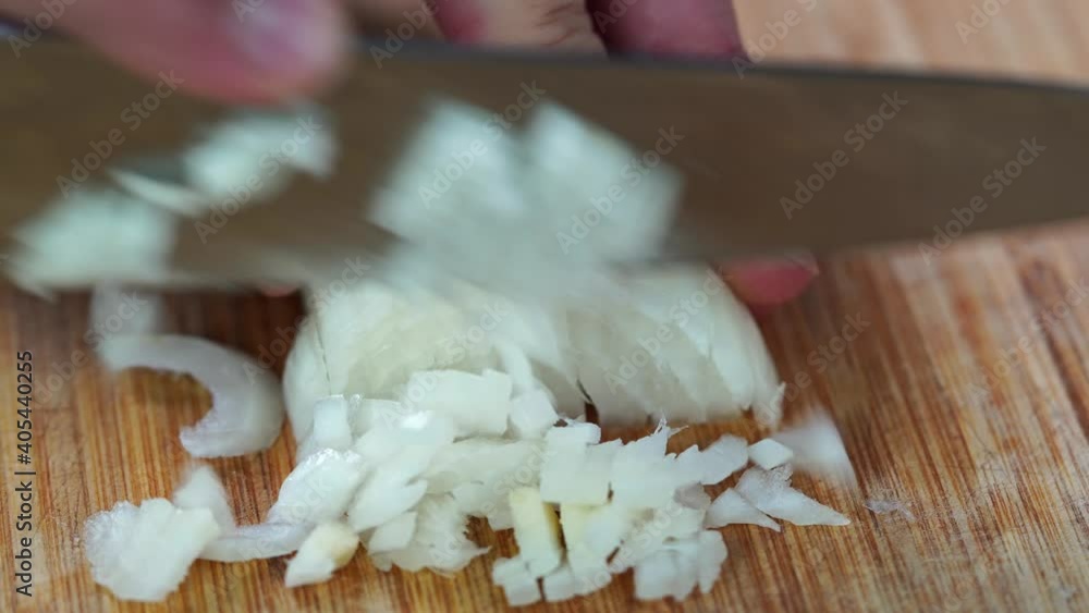 Chef cutting the onions on a wooden board Chef cutting the onions on a wooden board