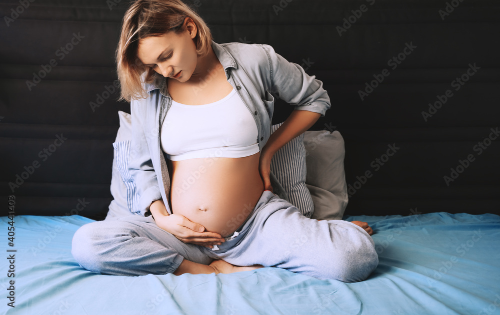 Pregnant Woman Suffering Lower Back Pain Or Headache Stock Photo Adobe Stock Pregnant Woman Suffering Lower Back Pain Or Headache Stock Photo Adobe Stock