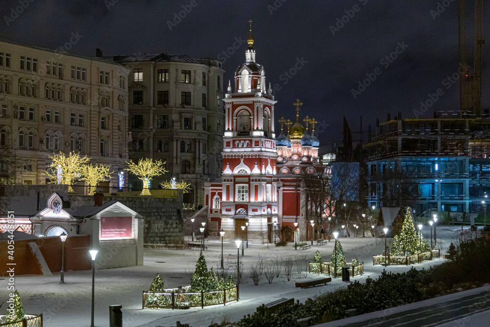 Moscow, Russia - February 04, 2020: View of the bell tower of Khram Georgiya Pobedonostsa in Zvezd Estrady Square between historic buildings of the urban city center
