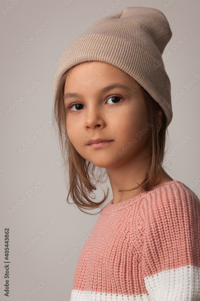 portrait of a beautiful girl in a striped sweater and knitted hat portrait of a beautiful girl in a striped sweater and knitted hat