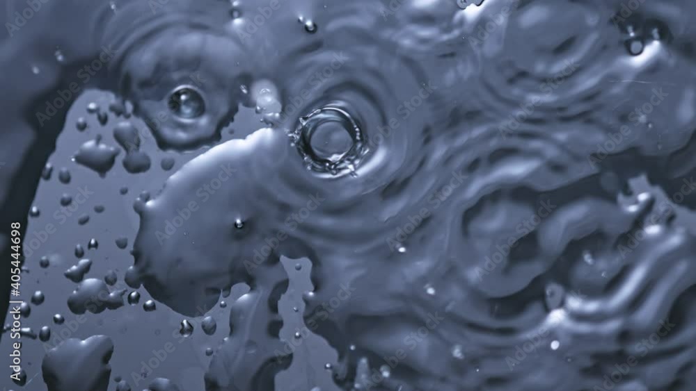 Super Slow Motion Top Shot of Water Drops Falling into Surface at 1000fps. Super Slow Motion Top Shot of Water Drops Falling into Surface at 1000fps.