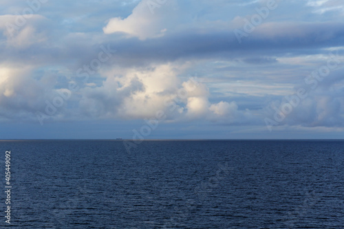 Beautiful landscape with blue sea and clouds above the horizon