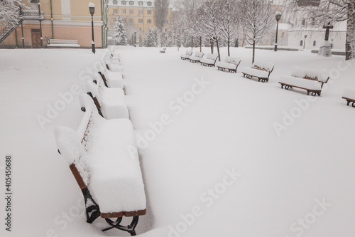 A row of benches covered with fresh snow in the park. Kiev.  Ukraine     