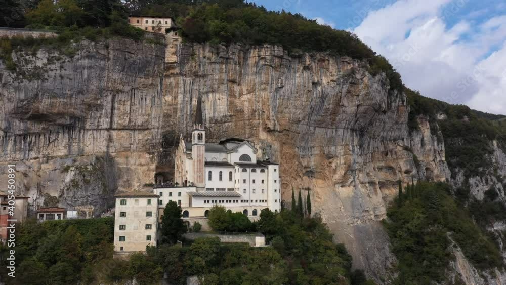 Unique church built in the rock. Panorama view of Madonna della Corona, Italy. Popular travel destination in Northern Italy. Flight by a drone. Unique church built in the rock. Panorama view of Madonna della Corona, Italy. Popular travel destination in Northern Italy. Flight by a drone.