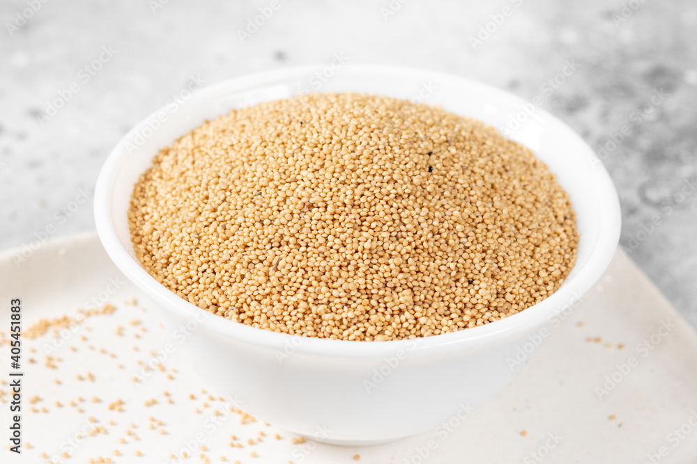 Amaranth. Amaranth seeds in a white bowl on a light gray kitchen table Amaranth. Amaranth seeds in a white bowl on a light gray kitchen table