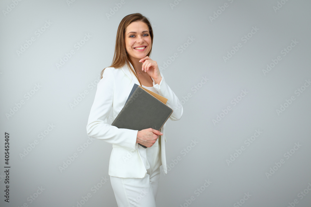 Woman teacher in white business suit holding books. Woman teacher in white business suit holding books.