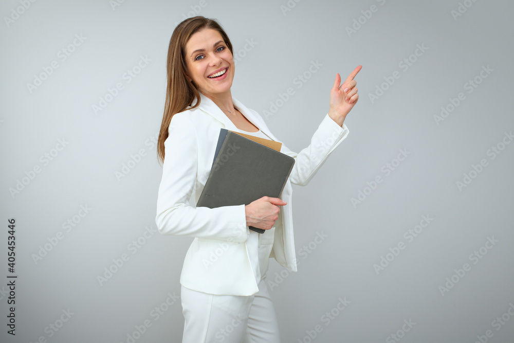 Woman teacher in white business suit holding books and pointing finger up. Woman teacher in white business suit holding books and pointing finger up.