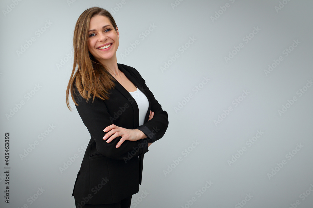 Smiling business woman wearing black suit standing with crossed arms. Smiling business woman wearing black suit standing with crossed arms.