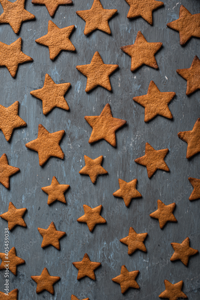 Christmas gingerbread cookies on a blue background with star shapes. Homemade making gingerbread for Christmas, in the form of stars on a blue background Christmas gingerbread cookies on a blue background with star shapes. Homemade making gingerbread for Christmas, in the form of stars on a blue background