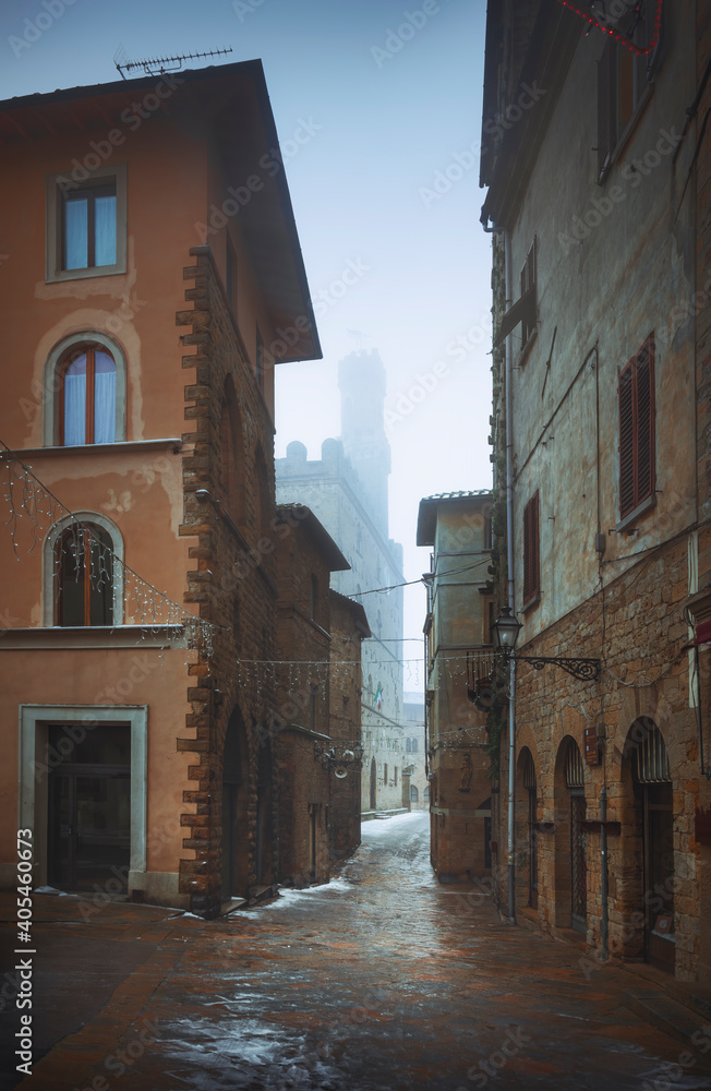 Volterra old townn during a snowfall in winter. Tuscany, Italy