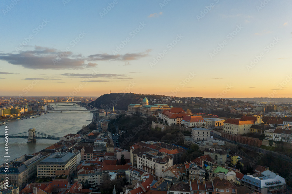 Aerial drone shot of Buda castle on hill during Budapest sunset hour