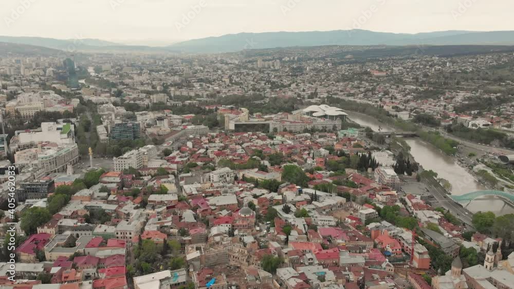 FAst motion fly over Tbilisi old city building roofs with modern buildings background panorama FAst motion fly over Tbilisi old city building roofs with modern buildings background panorama