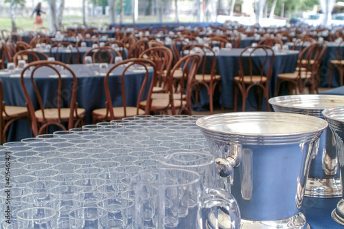 many round tables in preparetion for a lunch at a large meeting, glasses on forecast
 photo