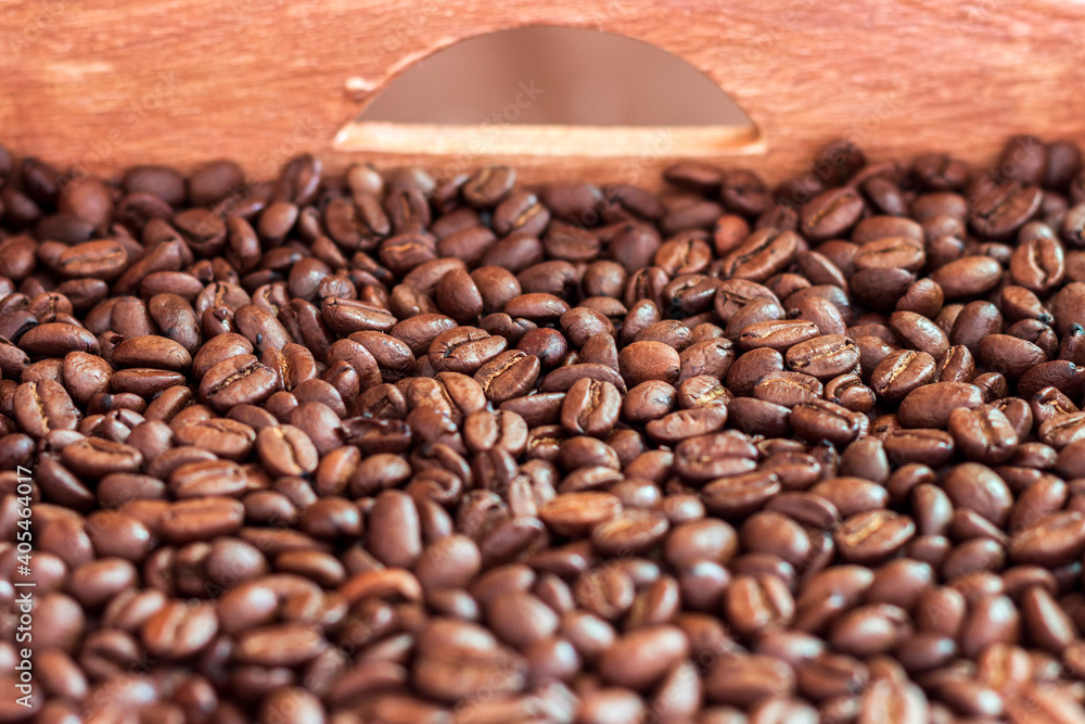 Fototapeta premium A wooden box full of roasted coffee beans.