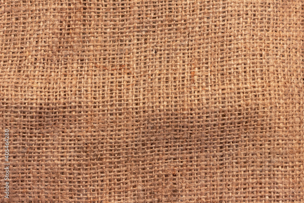 The texture of an uneven crumpled, roughly woven burlap. The texture of an uneven crumpled, roughly woven burlap.