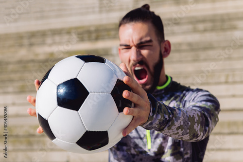 football ball in the hands of sportsman screaming © Raul Mellado
