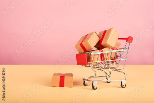 : Miniature shopping cart fill with many boxes.