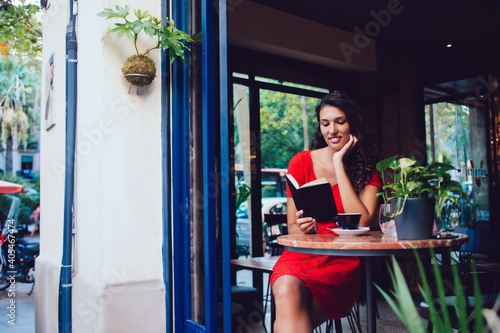 Canvas Print Peaceful ethnic lady delighting in book