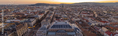 Panorama aerial drone shot of St. Stephen's Basilica over opera house in Budapest sunrise morning glow © Davidzfr