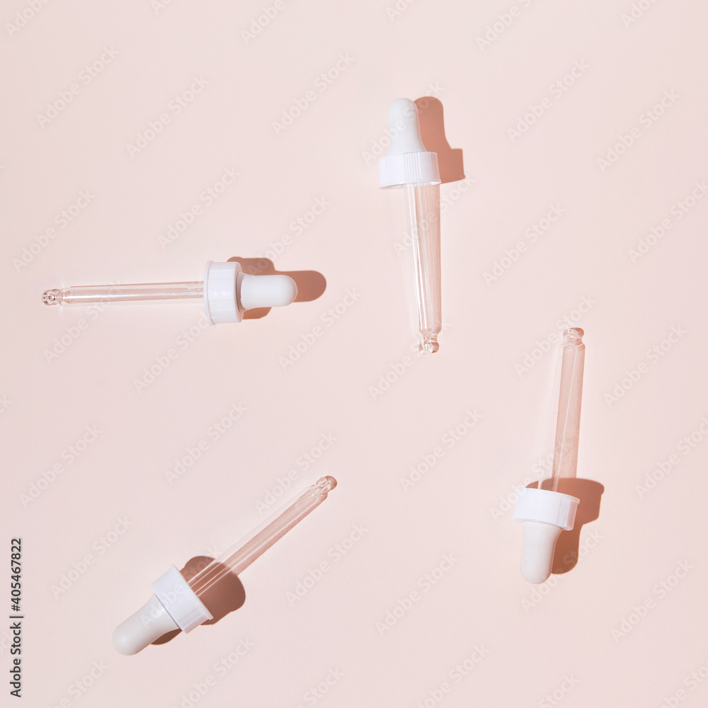Cosmetic serum droppers on pastel background. Skin care concept. Beauty rituals theme. Top view. Flat lay. Minimal style Cosmetic serum droppers on pastel background. Skin care concept. Beauty rituals theme. Top view. Flat lay. Minimal style