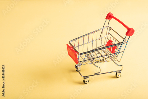 A miniature empty shopping cart.